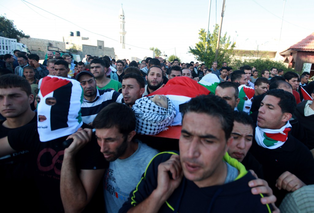 rami (front middle) carrying rushdi's body at his funeral (photo: fadi arouri)